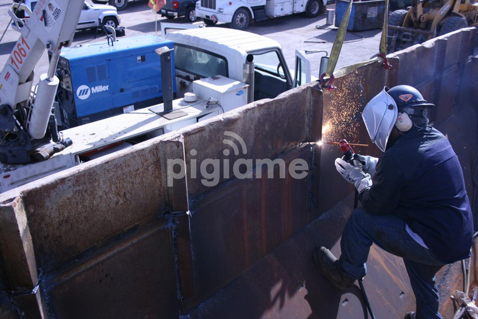 Welder cutting steel on site with a portable generator